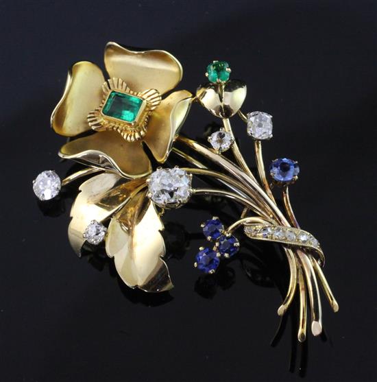 A gold, emerald, sapphire and diamond set floral spray brooch, 2.25in.